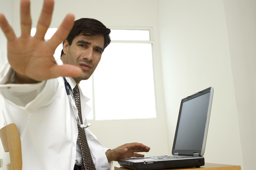 Close-up of a male doctor sticking out his hand charting for hours is tedious